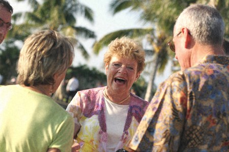 Three friends laughing together outdoors