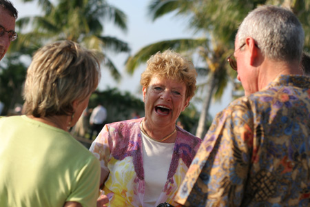 Three friends laughing together outdoors