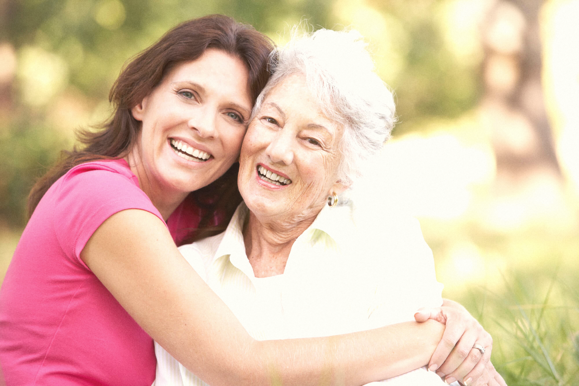 Adult daughter and older mother together, genuine warmth, natural light