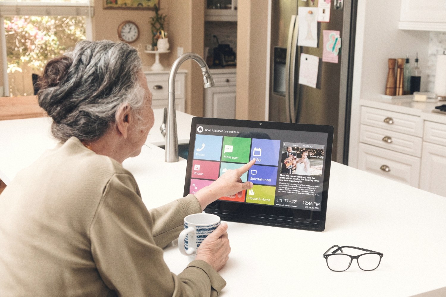 Older person using Lumin CareHub comfortably, close-up of hands on screen
