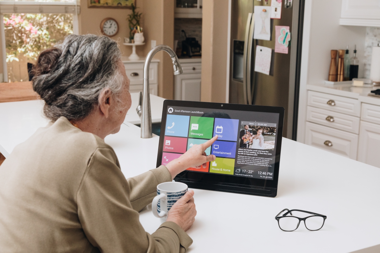 Older person using CareHub comfortably, close-up of hands on screen