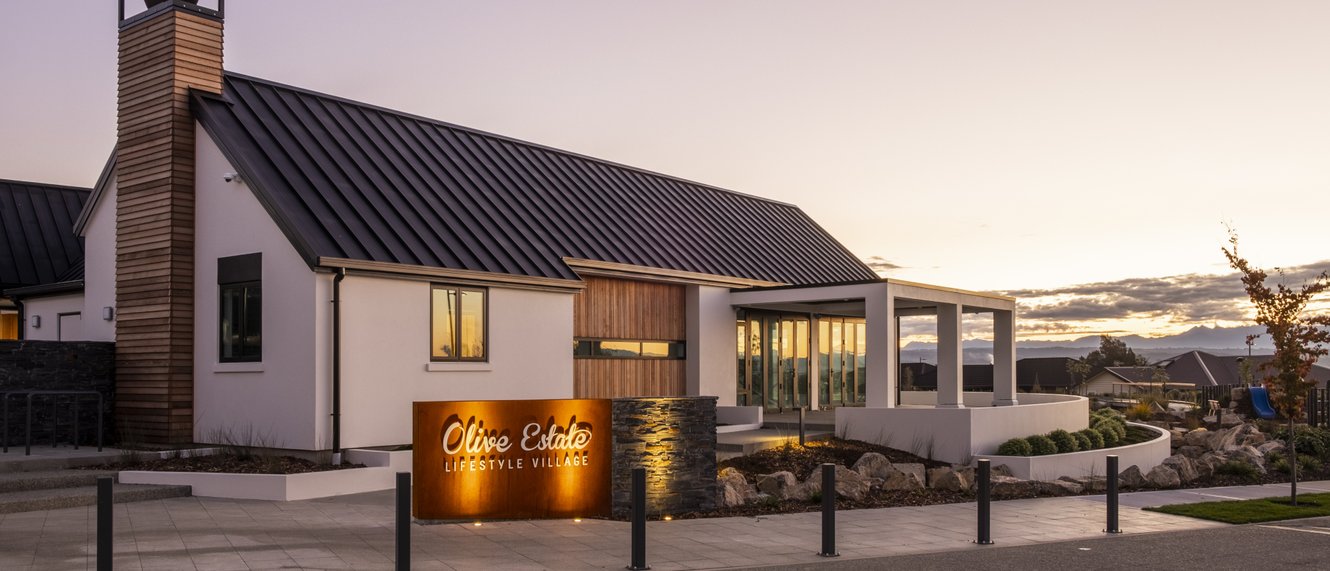 Olive Estate Lifestyle Village - modern lakehouse at dusk in Richmond, New Zealand