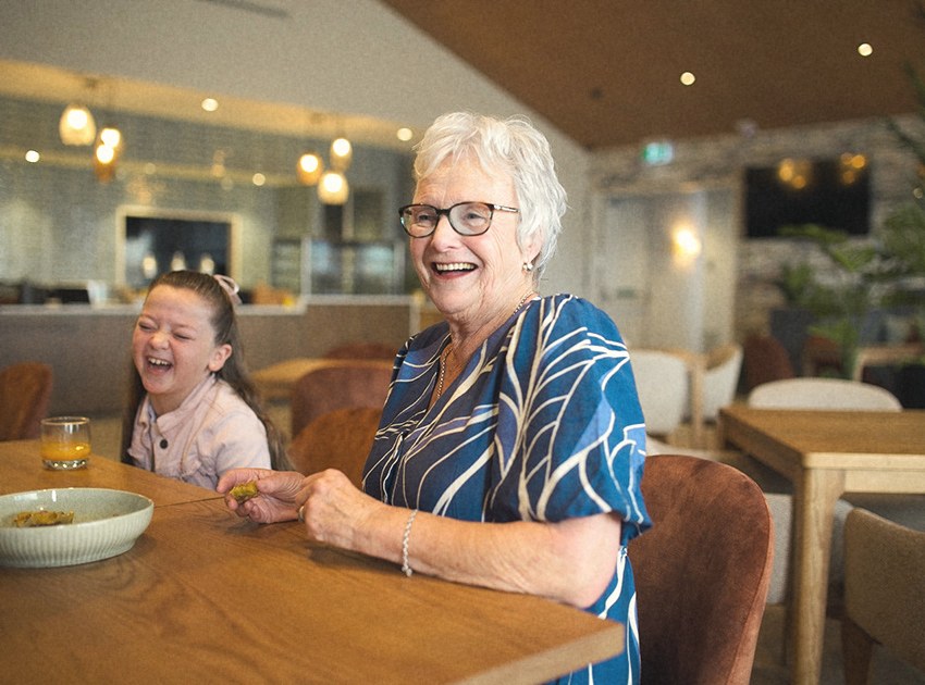 Sterling resident laughing with her granddaughter in the village café